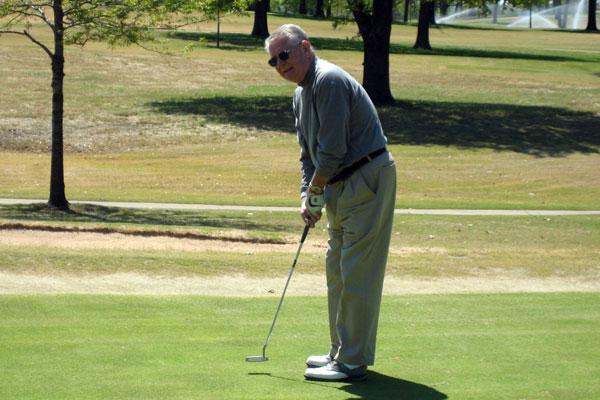 a man playing golf on a golf course