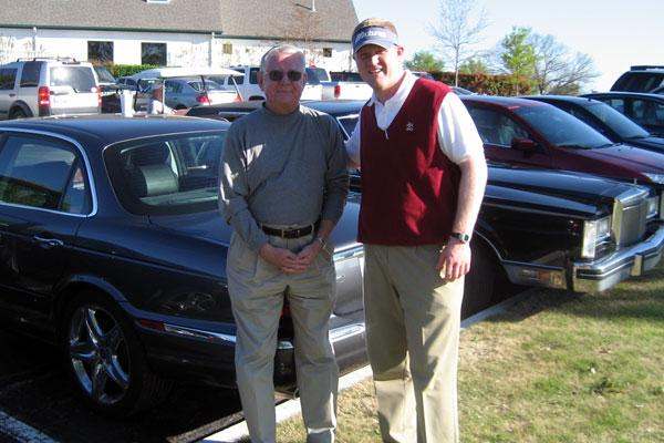 a man and a man standing next to a car