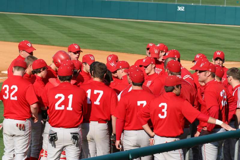a group of baseball players in red uniforms