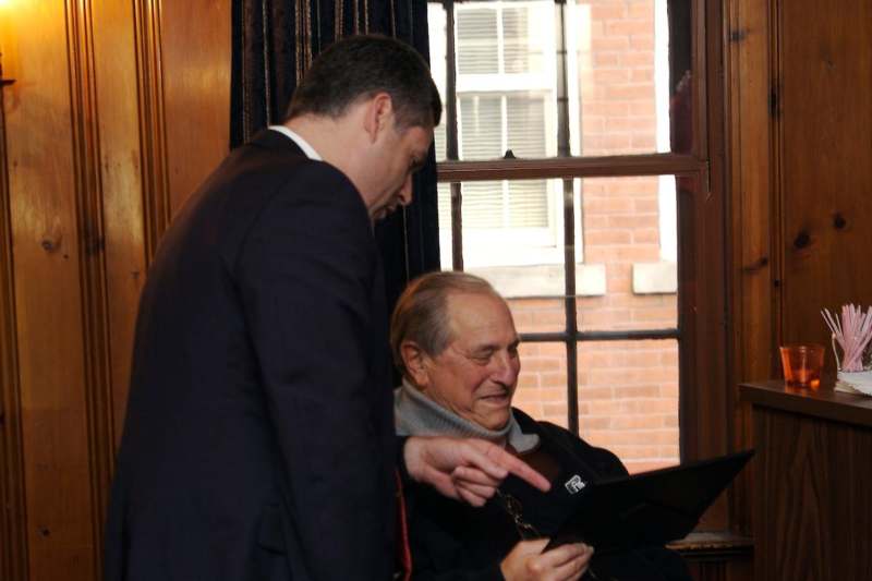 a man pointing at a man on a laptop