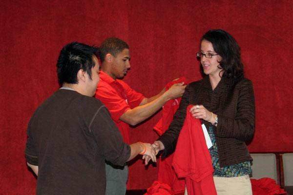 a woman holding a red shirt