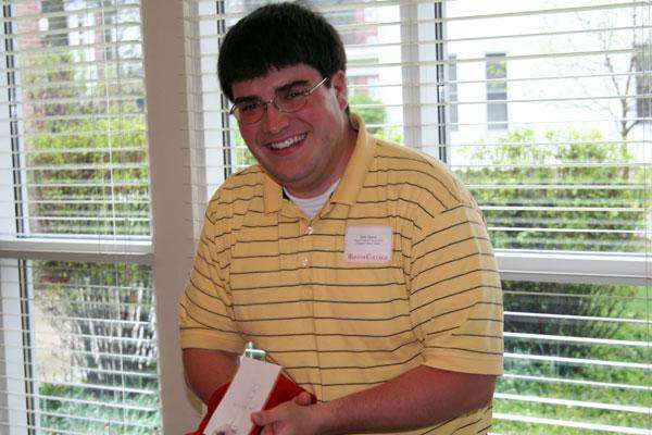 a man wearing glasses and a yellow shirt