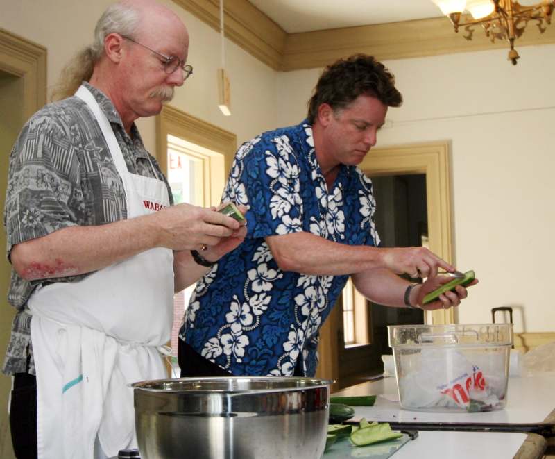 a couple of men preparing food