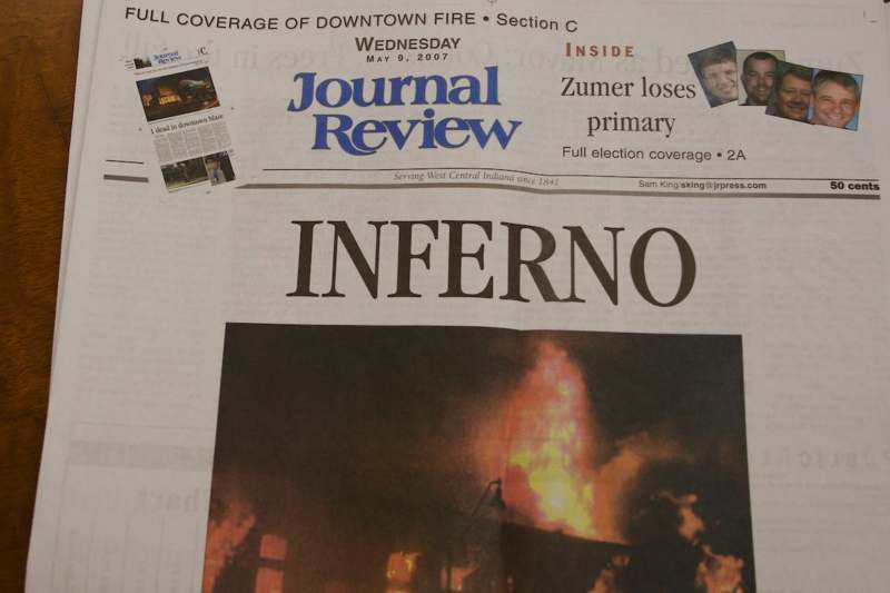 a newspaper with a picture of a fire