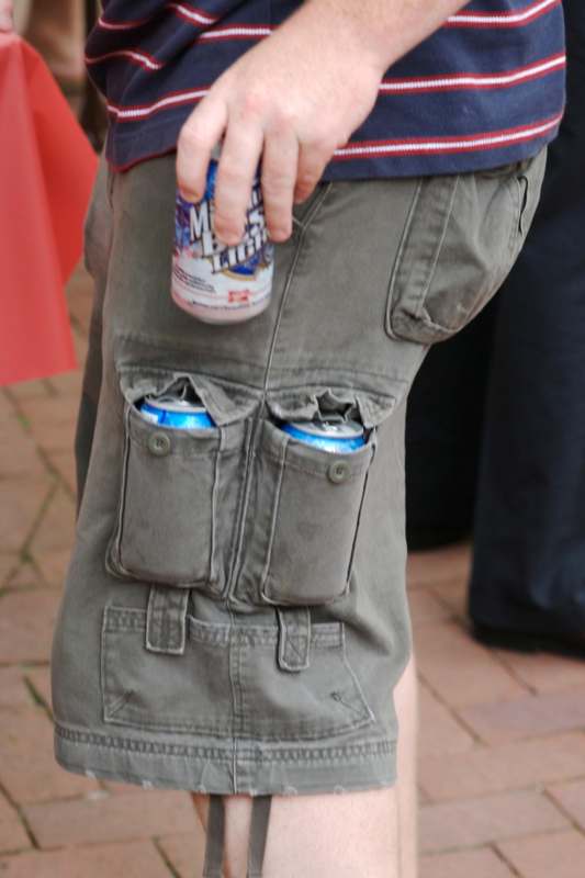 a person holding a can of beer