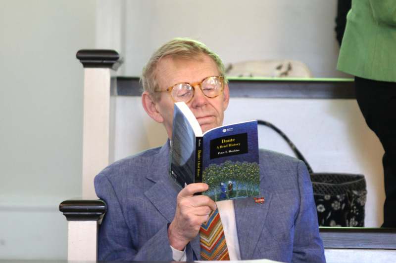 a man in a suit and tie reading a book