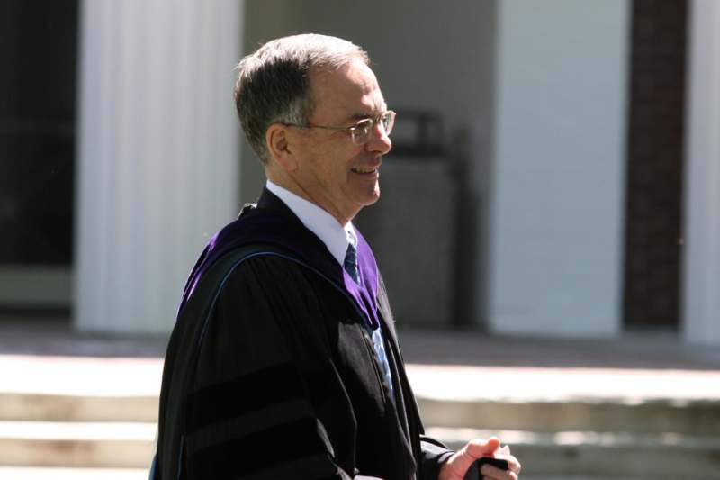 a man wearing a graduation gown