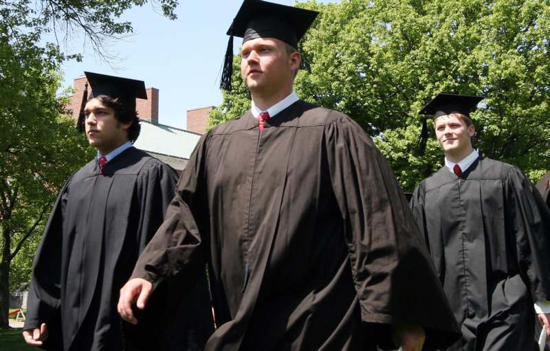 a group of men wearing graduation gowns