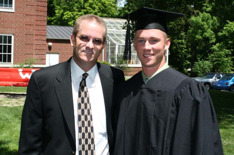 a man and a young man in graduation gowns