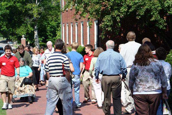 a group of people walking on a sidewalk