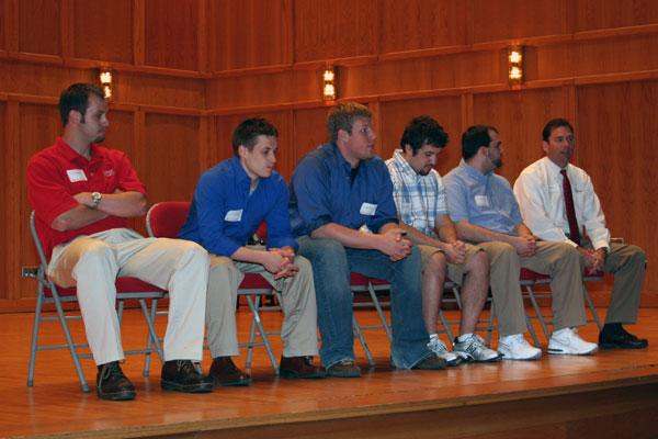 a group of people sitting on a stage