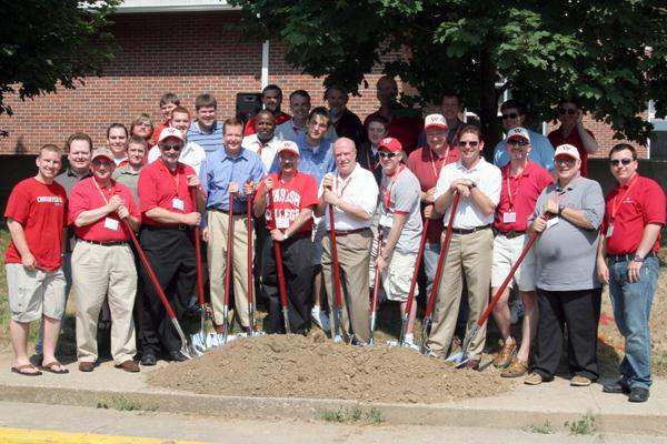 a group of people holding shovels