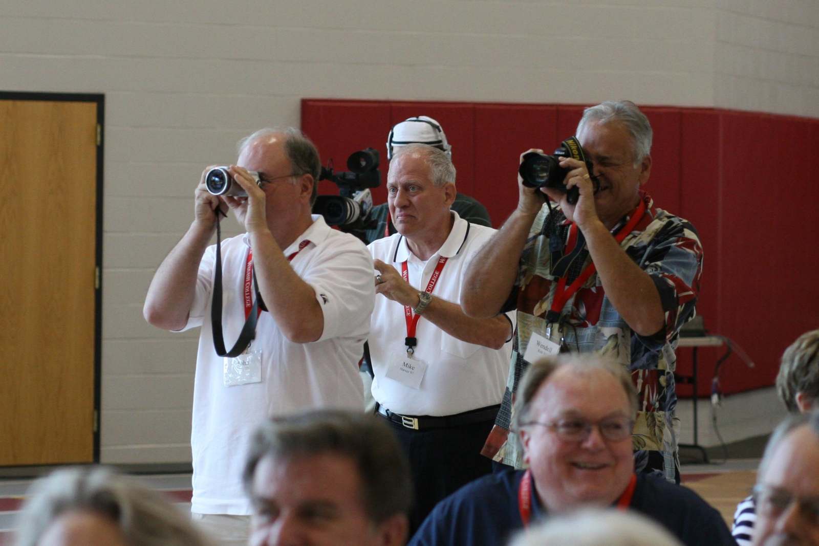 a group of men taking pictures