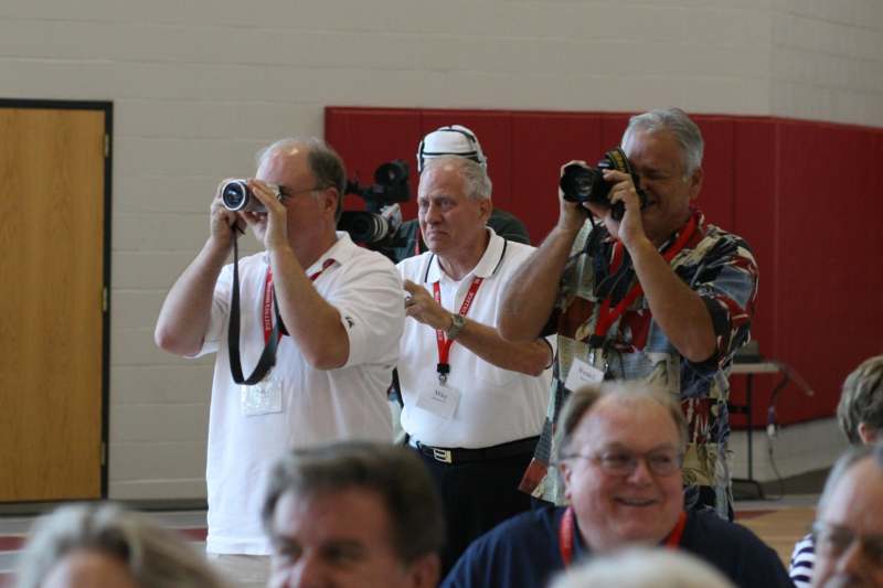 a group of men taking pictures
