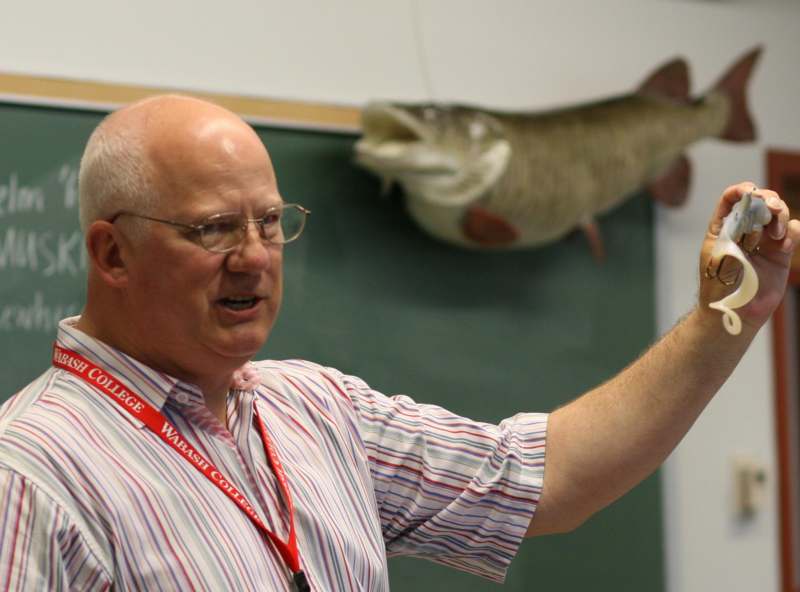 a man pointing at a fish