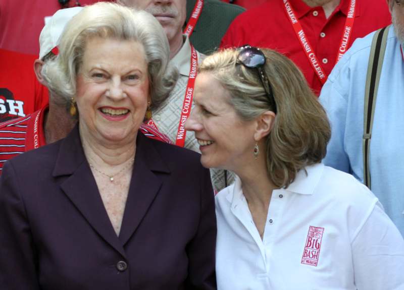a woman smiling with another woman