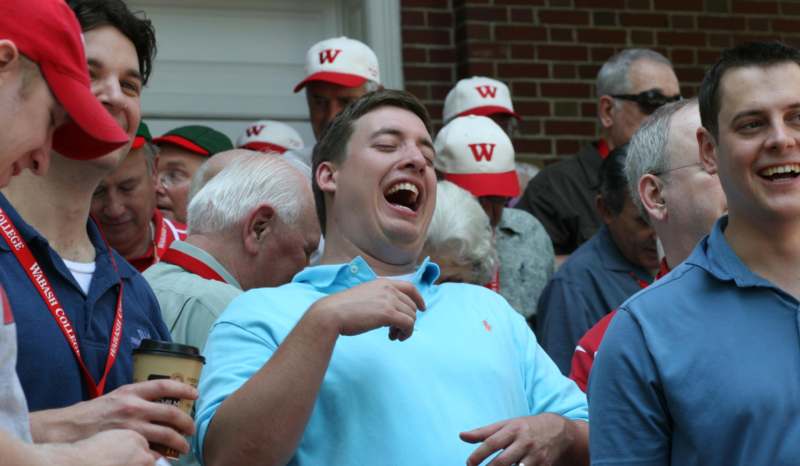 a man laughing in a crowd