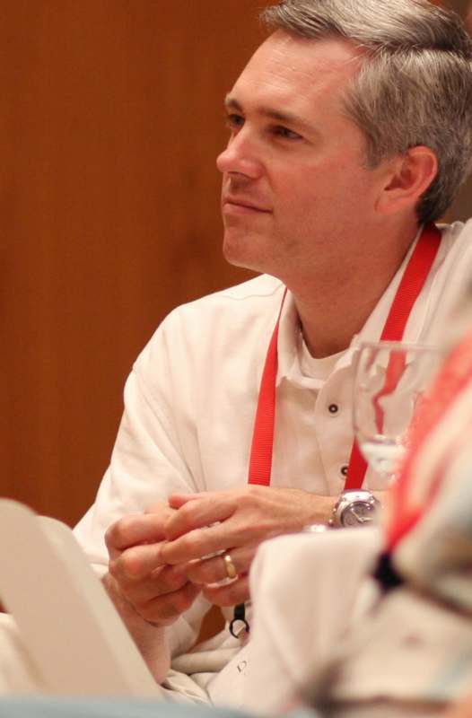 a man wearing a white shirt and red lanyard
