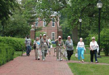 a group of people walking on a brick path