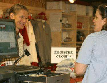 a man standing next to a cash register