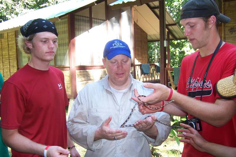 a man holding a snake