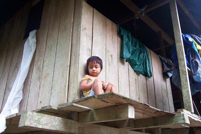 a child sitting on a wooden platform