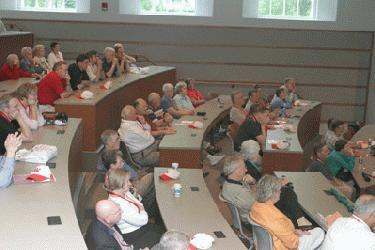 a group of people sitting in a lecture hall