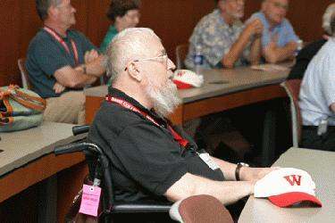 a man in a wheelchair at a conference