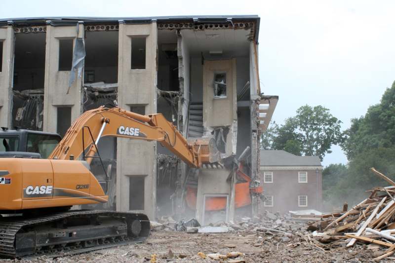 a construction vehicle in front of a building