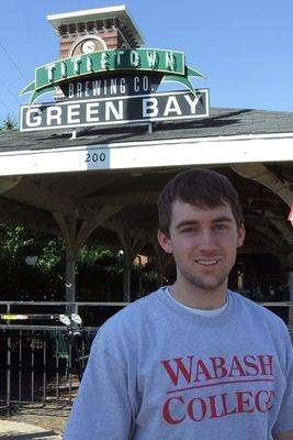 a man standing in front of a sign