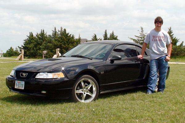 a man standing next to a car