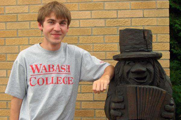 a man standing next to a statue