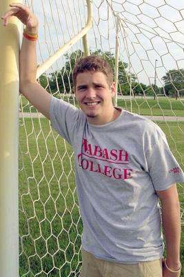 a man leaning on a goal