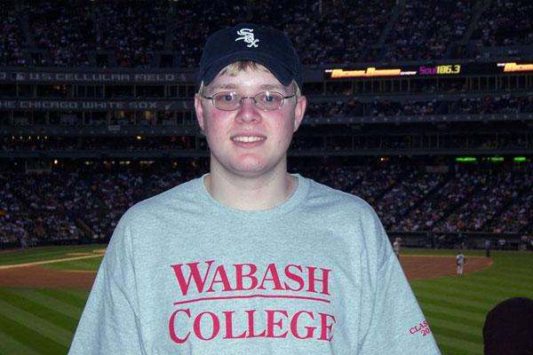 a man wearing a baseball hat and a sweatshirt