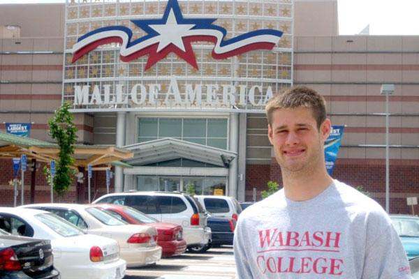 a man standing in front of a mall