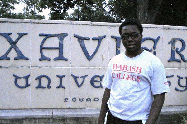 a man standing in front of a sign