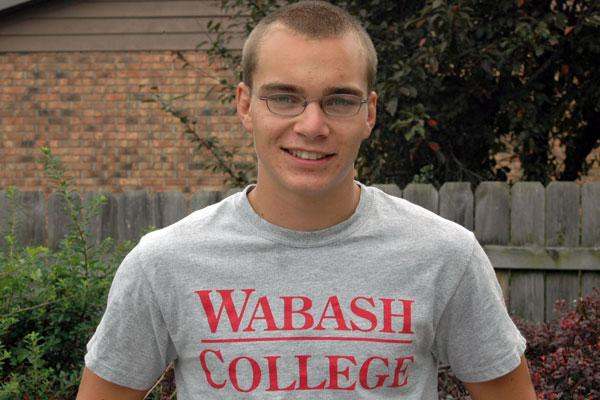 a man wearing glasses and a grey shirt