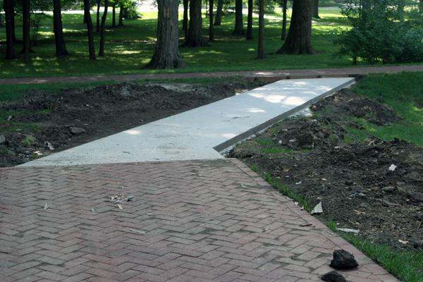a brick walkway with a path in the middle