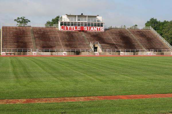 a stadium with a field and seating