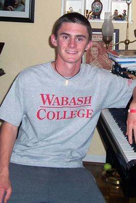 a young man sitting at a piano