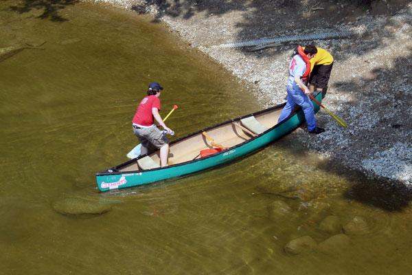 a couple of men in a canoe