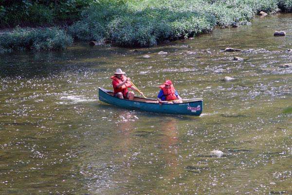a couple of people in a canoe