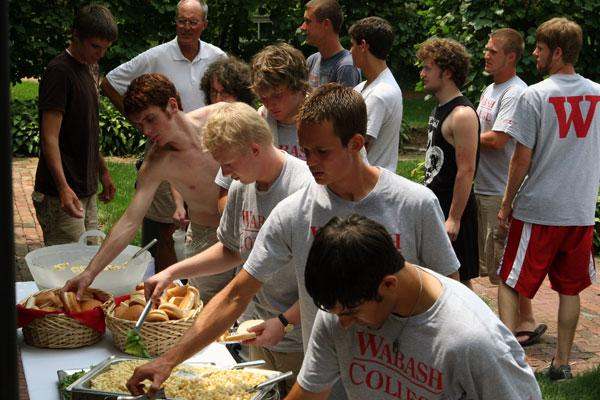 a group of people standing around a table