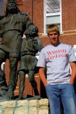 a man standing in front of a statue