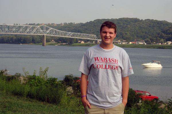 a man standing in front of a bridge