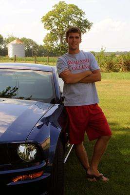 a man standing next to a car