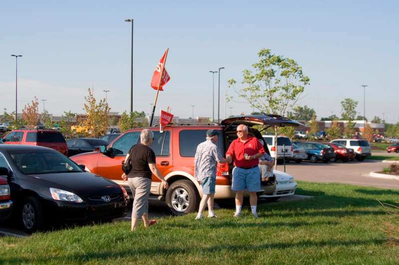 a group of people standing in a parking lot