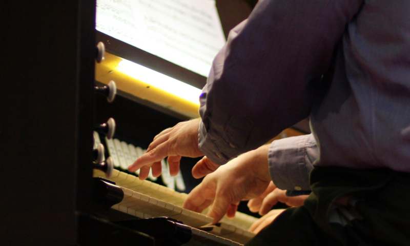 a close-up of hands playing a piano
