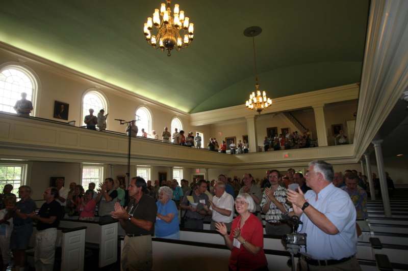 a group of people clapping in a church