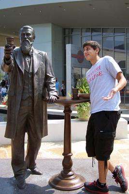 a man standing next to a statue